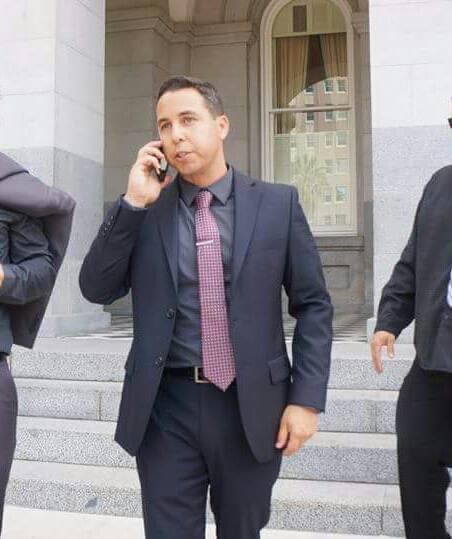 Michael Mendoza in a suit on the Capitol steps